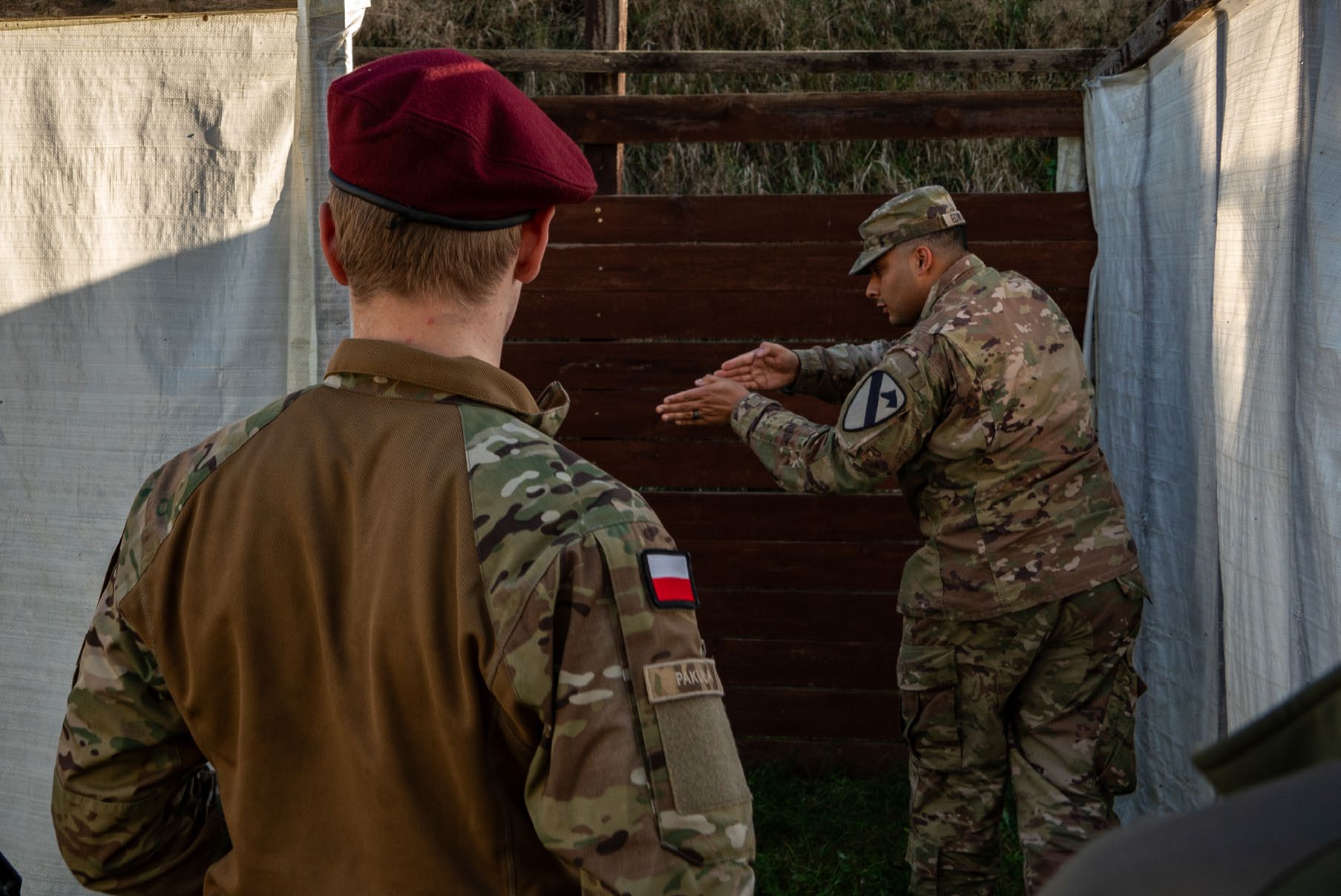 SSG Demetris Edwards, paralegal NCOIC assigned to the 1st Combat Aviation Brigade, demonstrates how to clear a room of hostiles
            at the Jana Wendy Shooting Training Center of the National Forest
            Service near Tuchola, Poland. (Credit: SGT Jacob Nunnenkamp)